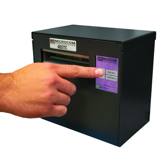 Hand pressing a button on a black electronic device with Microcom branding.