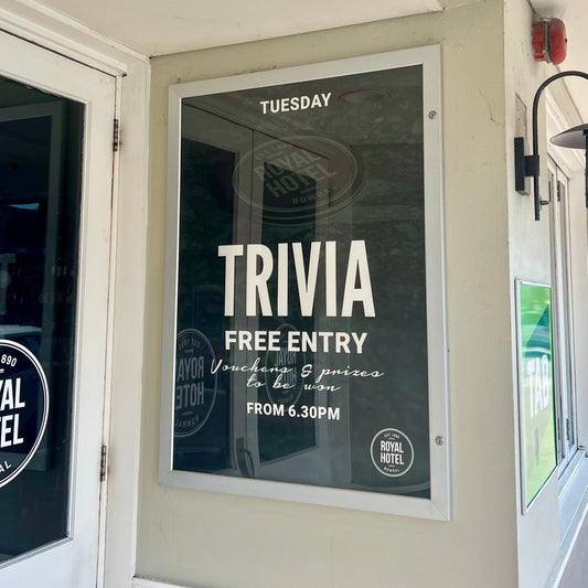 Trivia event poster on a wall at the Royal Hotel, with 'Royal Hotel' branding visible.